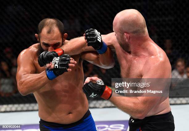 Tim Boetsch punches Johny Hendricks in their middleweight bout during the UFC Fight Night event at the Chesapeake Energy Arena on June 25, 2017 in...