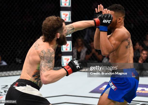 Michael Chiesa punches Kevin Lee in their lightweight bout during the UFC Fight Night event at the Chesapeake Energy Arena on June 25, 2017 in...