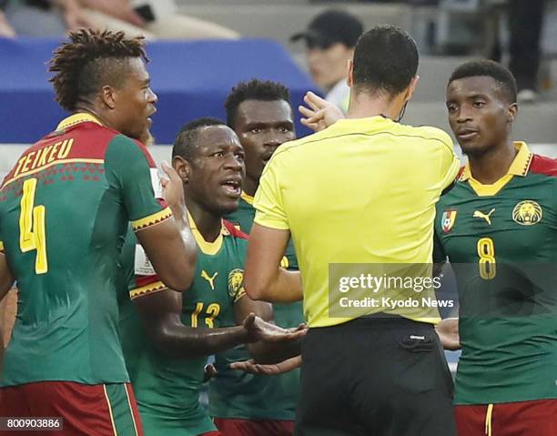 Cameroon defender Ernest Mabouka reacts after video replay led to him being shown red during the second half of a Group B match in Sochi, Russia, at...