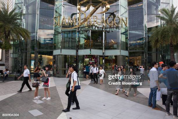 Pedestrians walk past an entrance to the Siam Paragon shopping mall in Bangkok, Thailand, on Wednesday, June 21, 2017. Stocks of consumer...