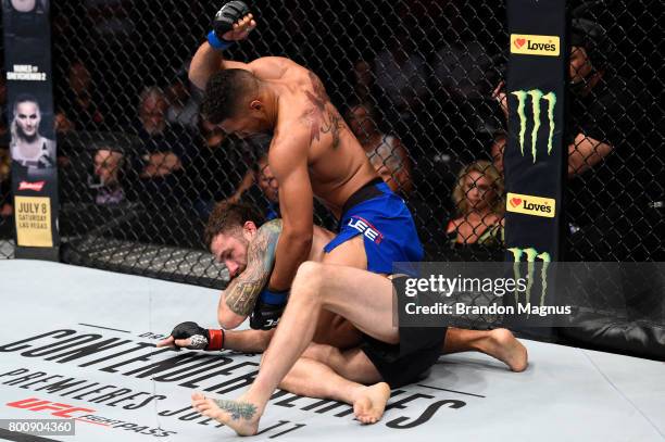 Kevin Lee punches Michael Chiesa in their lightweight bout during the UFC Fight Night event at the Chesapeake Energy Arena on June 25, 2017 in...