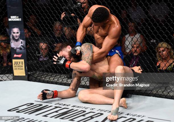 Kevin Lee punches Michael Chiesa in their lightweight bout during the UFC Fight Night event at the Chesapeake Energy Arena on June 25, 2017 in...