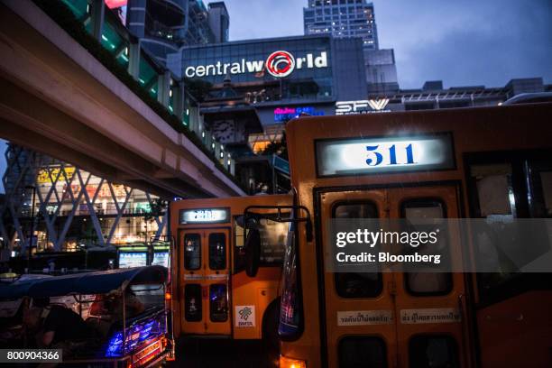 Buses sit in traffic outside the CentralWorld shopping mall at dusk in Bangkok, Thailand, on Wednesday, June 21, 2017. Stocks of consumer...