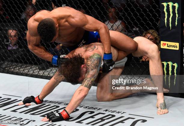 Kevin Lee punches Michael Chiesa in their lightweight bout during the UFC Fight Night event at the Chesapeake Energy Arena on June 25, 2017 in...