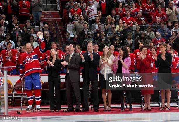Bob Gainey of the Montreal Canadiens stands by his family and waves to the crowd during his jersey retirement ceremony prior to a game against the...