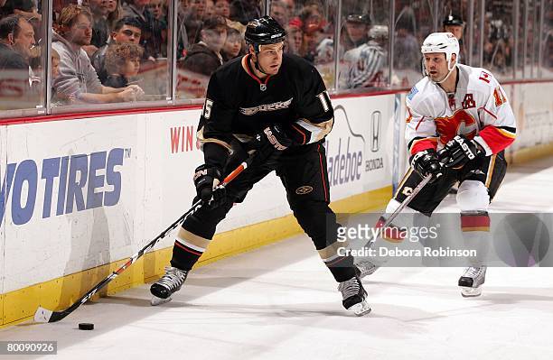 Ryan Getzlaf of the Anaheim Ducks moves the puck against Owen Nolan of the Calgary Flames at the Honda Center February 29, 2008 in Anaheim,...