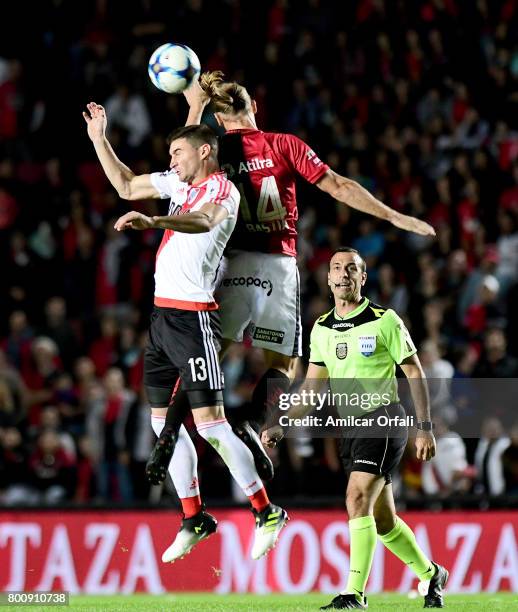 Adrian Bastia of Colon goes for a header with Lucas Alario of River Plate during a match between Colon and River Plate as part of Torneo Primera...