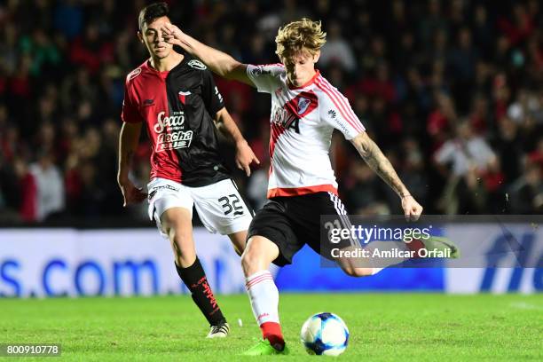 Ivan Rossi of River Plate kicks the ball while followed by Tomas Sandoval of Colon during a match between Colon and River Plate as part of Torneo...