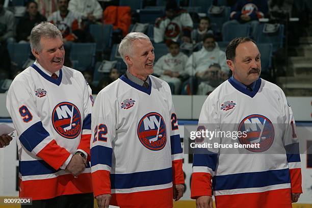 Clark Gillies, Mike Bossy and Bryan Trottier of "The "Core of the Four" New York Islanders Stanley Cup championships take part in a ceremony prior to...