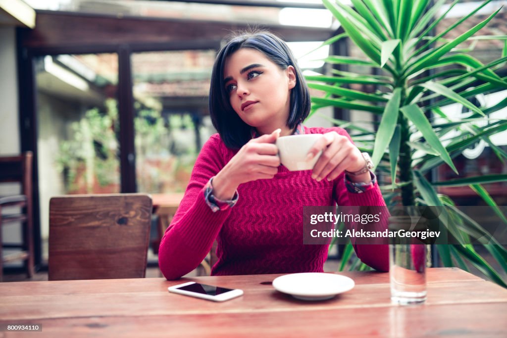 Young Female Enjoying Coffee Break at the Restaurant