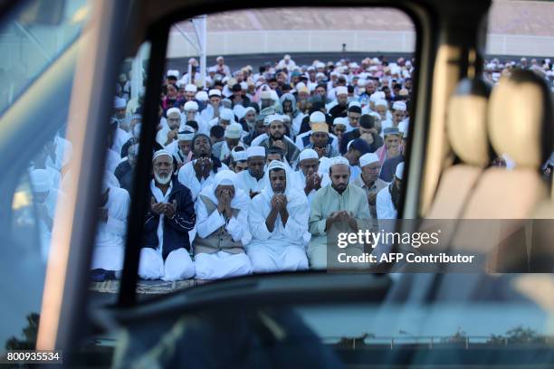 Muslims offer prayers during Eid al-Fitr at the velodrome de Champ-Fleuri in Saint-Denis de la Reunion on the French Indian Ocean island of Reunion...