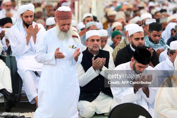 Muslims offer prayers during Eid al-Fitr at the velodrome de Champ-Fleuri in Saint-Denis de la Reunion on the French Indian Ocean island of Reunion...
