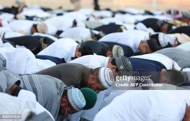 Muslims offer prayers during Eid al-Fitr at the velodrome de Champ-Fleuri in Saint-Denis de la Reunion on the French Indian Ocean island of Reunion...