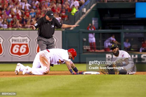 St. Louis Cardinals catcher Yadier Molina safely slide into second base head of the tag for a double against Pittsburgh Pirates second baseman Josh...