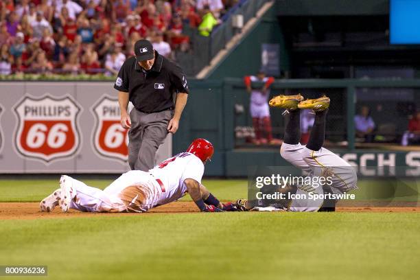 St. Louis Cardinals catcher Yadier Molina safely slide into second base head of the tag for a double against Pittsburgh Pirates second baseman Josh...