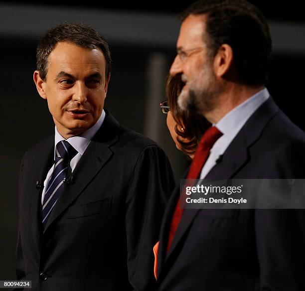 Spanish Prime Minister Jose Luis Rodriguez Zapatero smiles with opposition Popular Party leader Mariano Rajoy before taking part in their second TV...