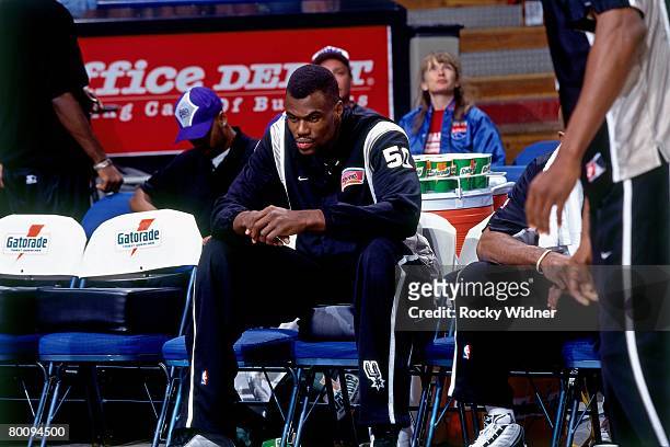David Robinson of the San Antonio Spurs sits on the bench during a game played in 1998 at the Alamo Dome in San Antonio, Texas. NOTE TO USER: User...