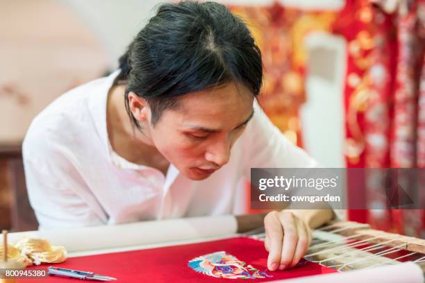 chinese traditional crafters is making the embroidery - gold embroidery stock pictures, royalty-free photos & images