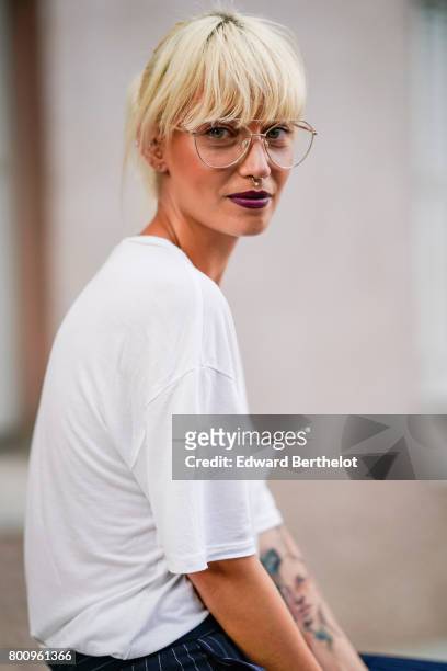Guest wears a white t-shirt, glasses, outside the Kenzo show, during Paris Fashion Week - Menswear Spring/Summer 2018, on June 25, 2017 in Paris,...