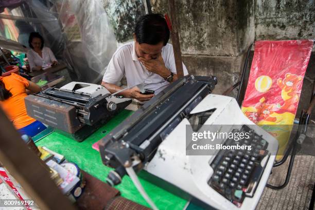 Typist sits in front of a typewriter while waiting for customers in Yangon, Myanmar, on Friday, June 16, 2017. A pariah state for decades, Myanmars...