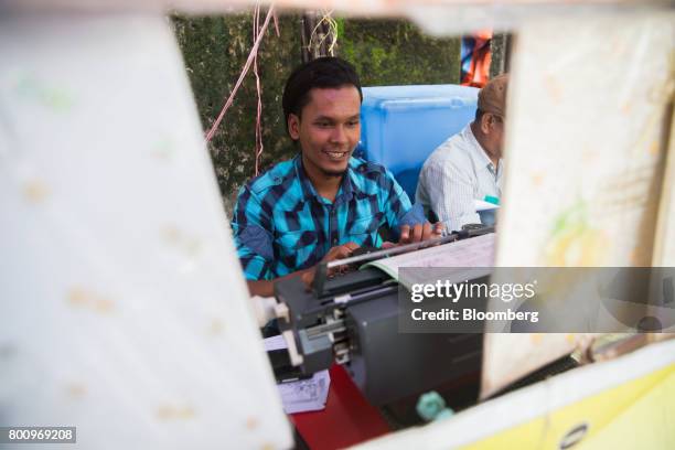 Typist types a letter on a typewriter in Yangon, Myanmar, on Friday, June 16, 2017. A pariah state for decades, Myanmars recent emergence from...