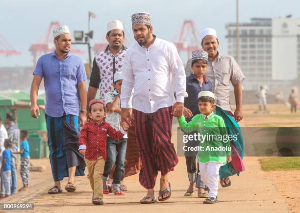 Sri Lankan Muslims arrive to attend a Eid al-Fitr prayer during the Eid al-Fitr holiday at the Galle Face green in Colombo, Sri Lanka on July 26,...