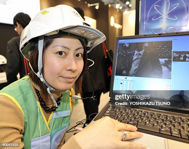 Japan's safety goods maker Tanizawa employee displays a prototype model of a mobile utility helmet "U-met", equipped with a QVGA mobile camera, a GPS...