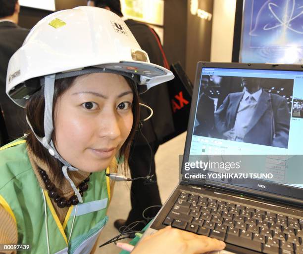 Japan's safety goods maker Tanizawa employee displays a prototype model of a mobile utility helmet "U-met", equipped with a QVGA mobile camera, a GPS...