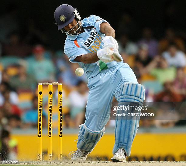 India's Mahendra Dhoni drives the ball during the second final in the one-day triangular series cricket match against Australia in Brisbane on March...