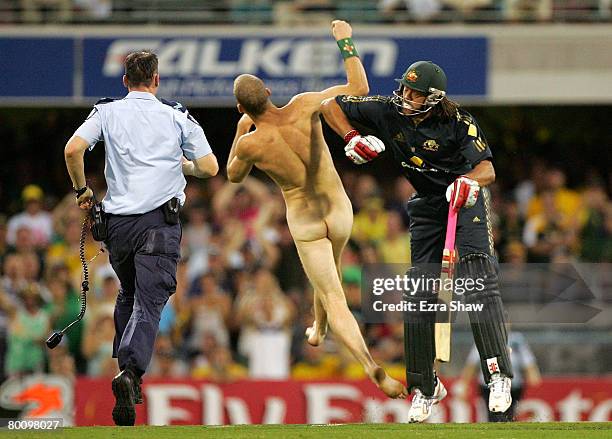 Andrew Symonds of Australia knocks over a streaker who ran onto the field during the Commonwealth Bank Series One Day International second final...