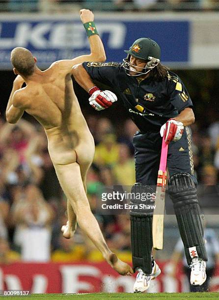 Andrew Symonds of Australia knocks over a streaker who ran onto the field during the Commonwealth Bank Series One Day International second final...