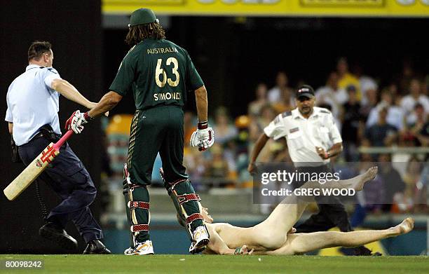 Australia's Andrew Symonds clashes with a streaker during the second final in the one-day triangular series cricket match in Brisbane on March 4,...