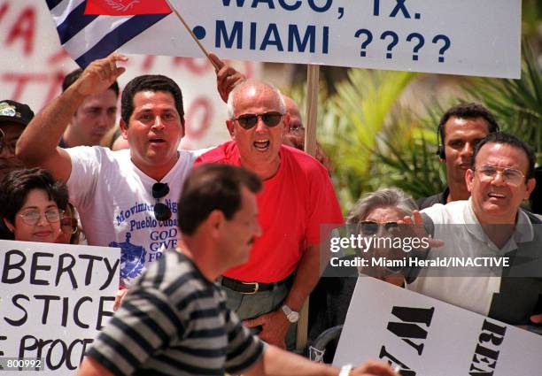 Protesters voice their support as Lazaro Gonzalez, Elian Gonzalez's great Uncle walks by April 11, 2000 in Little Havana, Miami. Plans for a meeting...