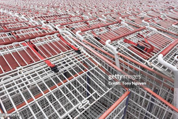 shopping cart (trolley) pattern in front of a supermarket, ready for customers to use. - coles supermarket stock pictures, royalty-free photos & images