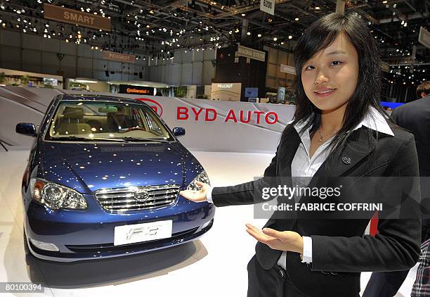 Hostess shows the F3 car model of the Chinese automobile manufacturer BYD during the press day at the 78th Geneva International Motor Show, on March...