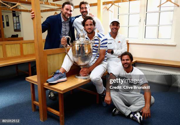 Feliciano Lopez of Spain and his team pose with the trophy in the locker room after winning the mens singles final against Marin Cilic of Croati...