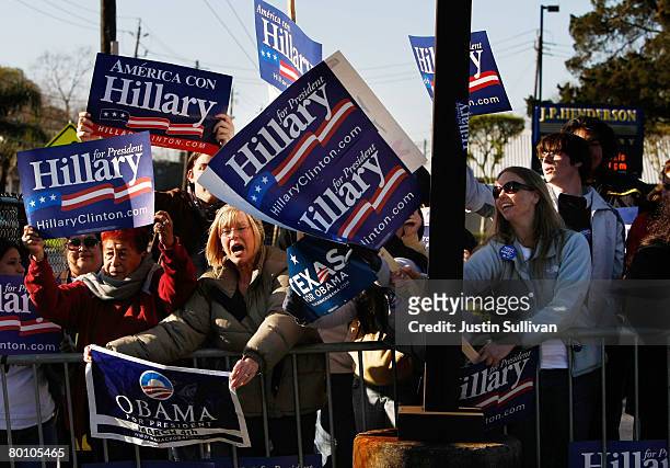 Supporters of Democratic presidential hopeful U.S. Sen. Hillary Clinton try to block a woman holding a sign in support of U.S. Sen. Barack Obama...