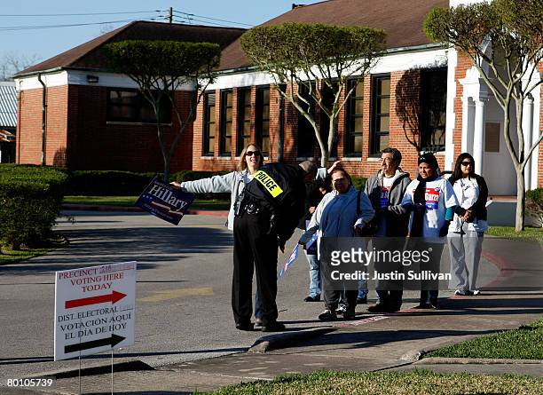 Supporters of democratic presidential hopeful U.S. Sen. Hillary Clinton are screened by a police officer as they enter a secured area outside of a...