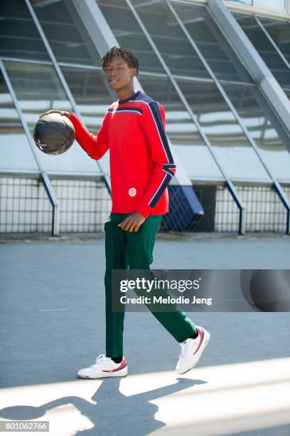 Abdulaye Niang plays basketball outside the Lanvin show on June 25, 2017 in Paris, France.