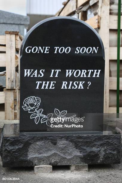 Newly made granite tombstone carved with a strange message outside the workshop of a tombstone designer in Mississauga, Ontario, Canada.