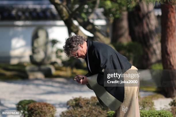 bowing after playing shakuhachi - bow musical equipment stock pictures, royalty-free photos & images