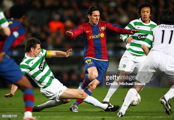 Lionel Messi of Barcelona is tackled by Stephen McManus of Celtic during the UEFA Champions League 2nd leg of the First knockout round match between...