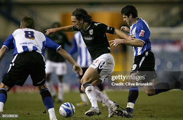 Jonathan Greening of West Bromwich Albion in action with Adam Bolder and Burton O'Brien of Sheffield Wednesday during the Coca-Cola Championship...