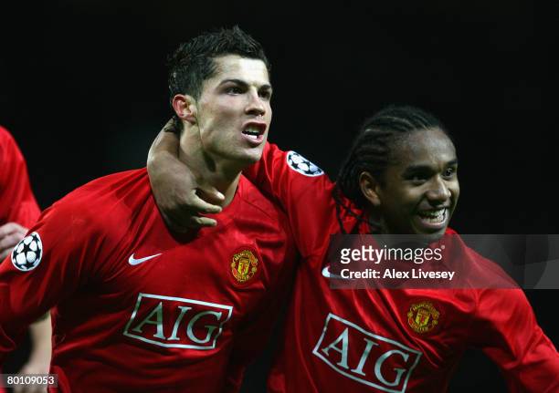 Cristiano Ronaldo of Manchester United celebrates scoring the opening goal with team mate Anderson during the UEFA Champions League first knockout...