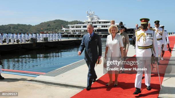 Camilla, Duchess of Cornwall and Prince Charles, Prince of Wales walk down the red carpet from the yacht 'Leander' as they arrive at Staubles Bay on...