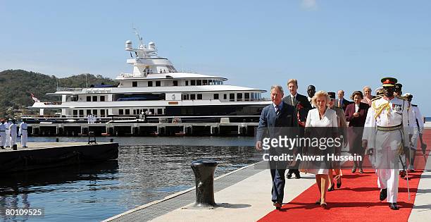 Camilla, Duchess of Cornwall and Prince Charles, Prince of Wales walk down the red carpet from the yacht 'Leander' as they arrive at Staubles Bay on...