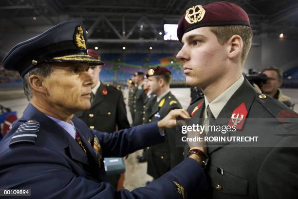 Commander of the Dutch armed forces Dick Berlijn pins a medal to an injured soldier in Arnhem, on March 4, 2008. Around 1500 present soldiers who...