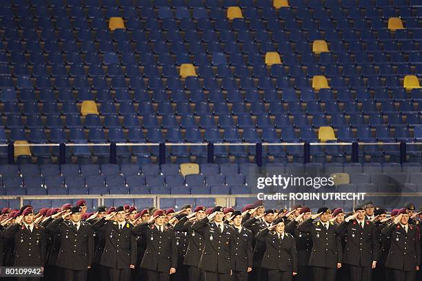 Soldiers salute in the Arnhem football stadium Gelredome on March 4 during one minute of silence for the Dutch soldiers that were killed in action in...