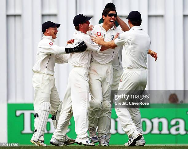 Alastair Cook of England is congratulated by team-mates after catching Stephen Fleming of New Zealand during day one of the First Test match between...