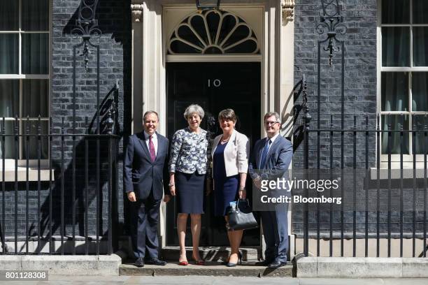 Left to right, Nigel Dodds, deputy leader of the Democratic Unionist Party , Theresa May, U.K. Prime minister, Arlene Foster, leader of the...